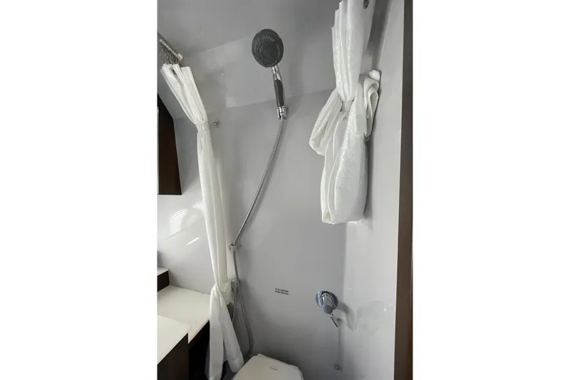  Yacht Photos Pics 2023 Cruisers Yachts 38 GLS I/O bathroom with shower and white curtain.