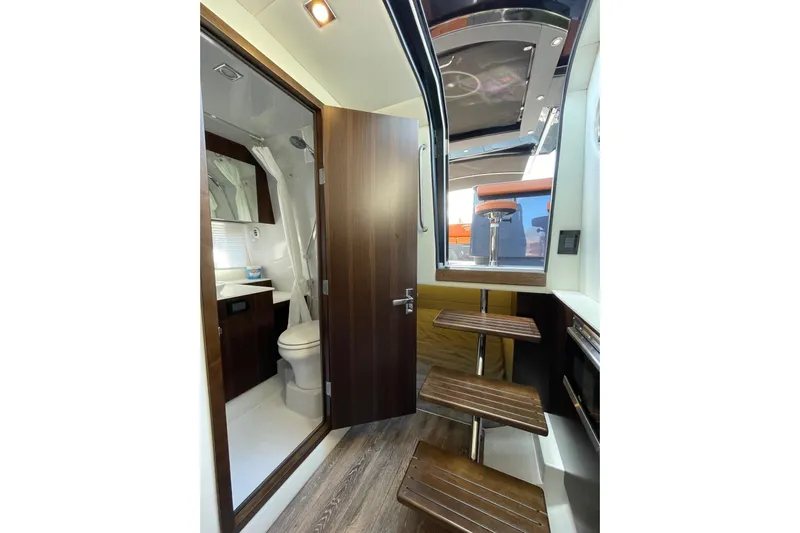  Yacht Photos Pics Interior of 2023 Cruisers Yachts 38 GLS I/O, featuring a compact bathroom and wooden stairs.