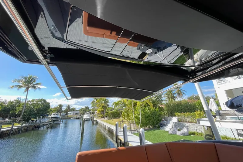 Yacht Photos Pics 2023 Cruisers Yachts 38 GLS I/O with retractable canopy, docked by a scenic canal.