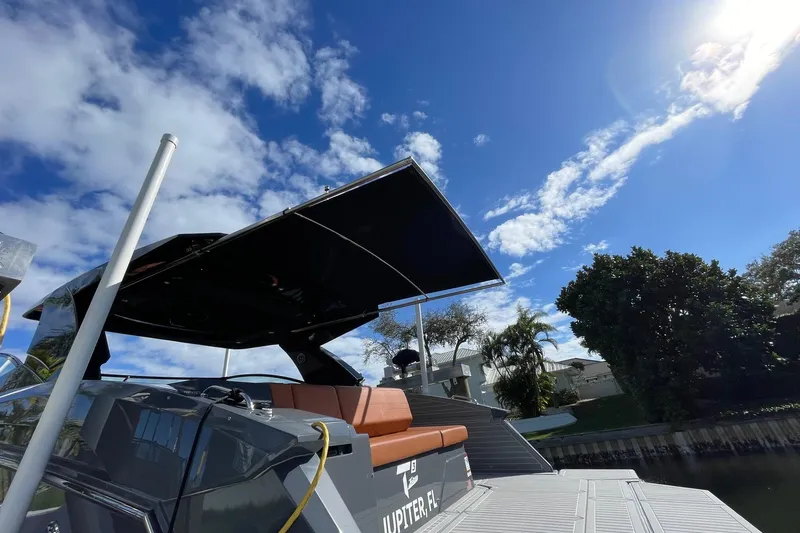  Yacht Photos Pics 2023 Cruisers Yachts 38 GLS I/O with canopy, docked under a clear blue sky.