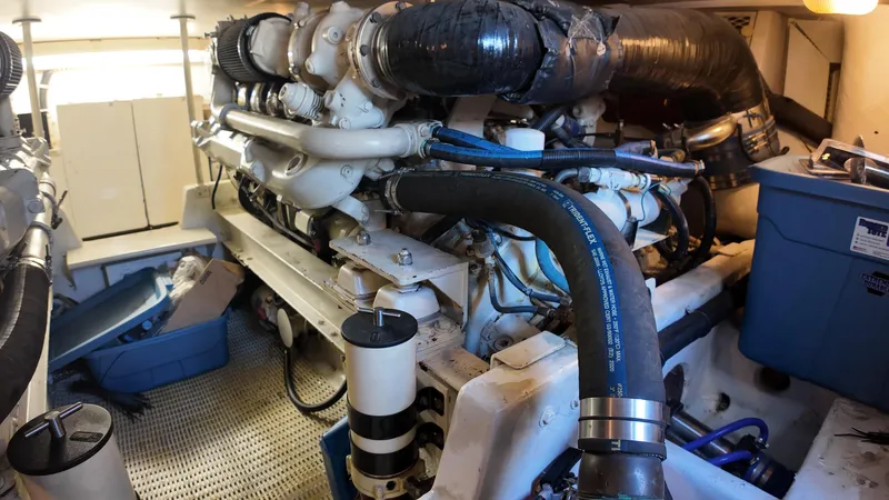  Yacht Photos Pics Engine room of a 1999 Viking 47 Convertible yacht, showcasing mechanical components.