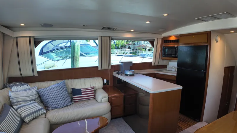  Yacht Photos Pics Interior of 1999 Viking 47 Convertible yacht with cozy seating and modern kitchen.