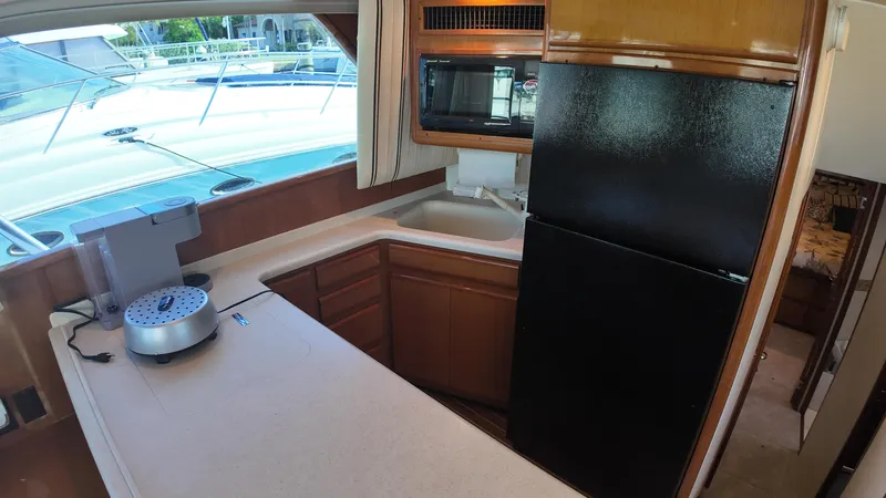  Yacht Photos Pics 1999 Viking 47 Convertible yacht kitchen with modern appliances and spacious countertops.