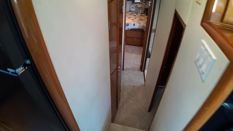  Yacht Photos Pics Interior hallway of 1999 Viking 47 Convertible yacht, leading to bedroom.
