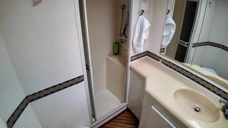  Yacht Photos Pics Bathroom interior of 1999 Viking 47 Convertible yacht with shower and sink.