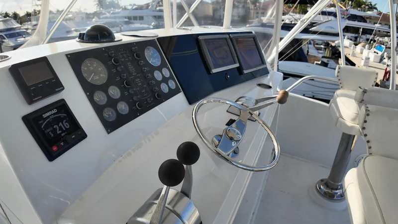  Yacht Photos Pics 1999 Viking 47 Convertible yacht helm with navigation instruments and steering wheel.