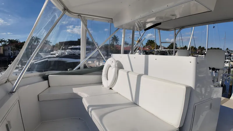  Yacht Photos Pics 1999 Viking 47 Convertible yacht interior with white seating and marina view.