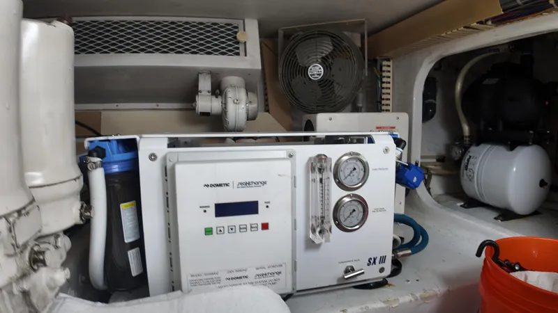  Yacht Photos Pics Engine room of 1999 Viking 47 Convertible with watermaker system and fan.