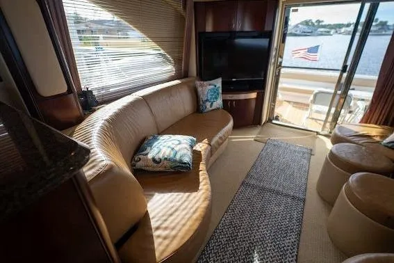 Low Hours! Yacht Photos Pics Luxurious 2006 Sea Ray 580 Sedan Bridge interior with leather seating and waterfront view.