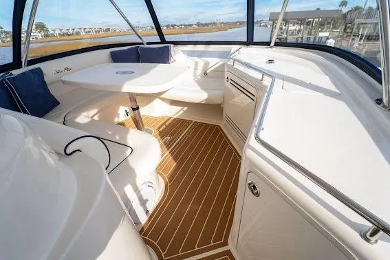 Low Hours! Yacht Photos Pics 2006 Sea Ray 580 Sedan Bridge interior with elegant seating and wooden flooring.