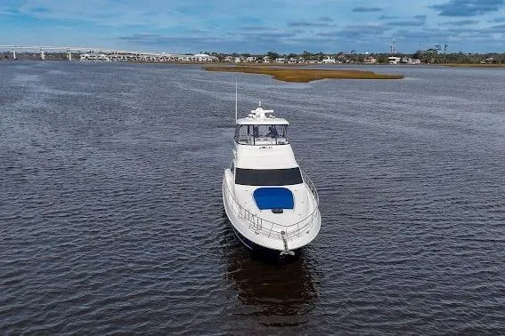 Low Hours! Yacht Photos Pics 2006 Sea Ray 580 Sedan Bridge yacht on open water, under a partly cloudy sky.