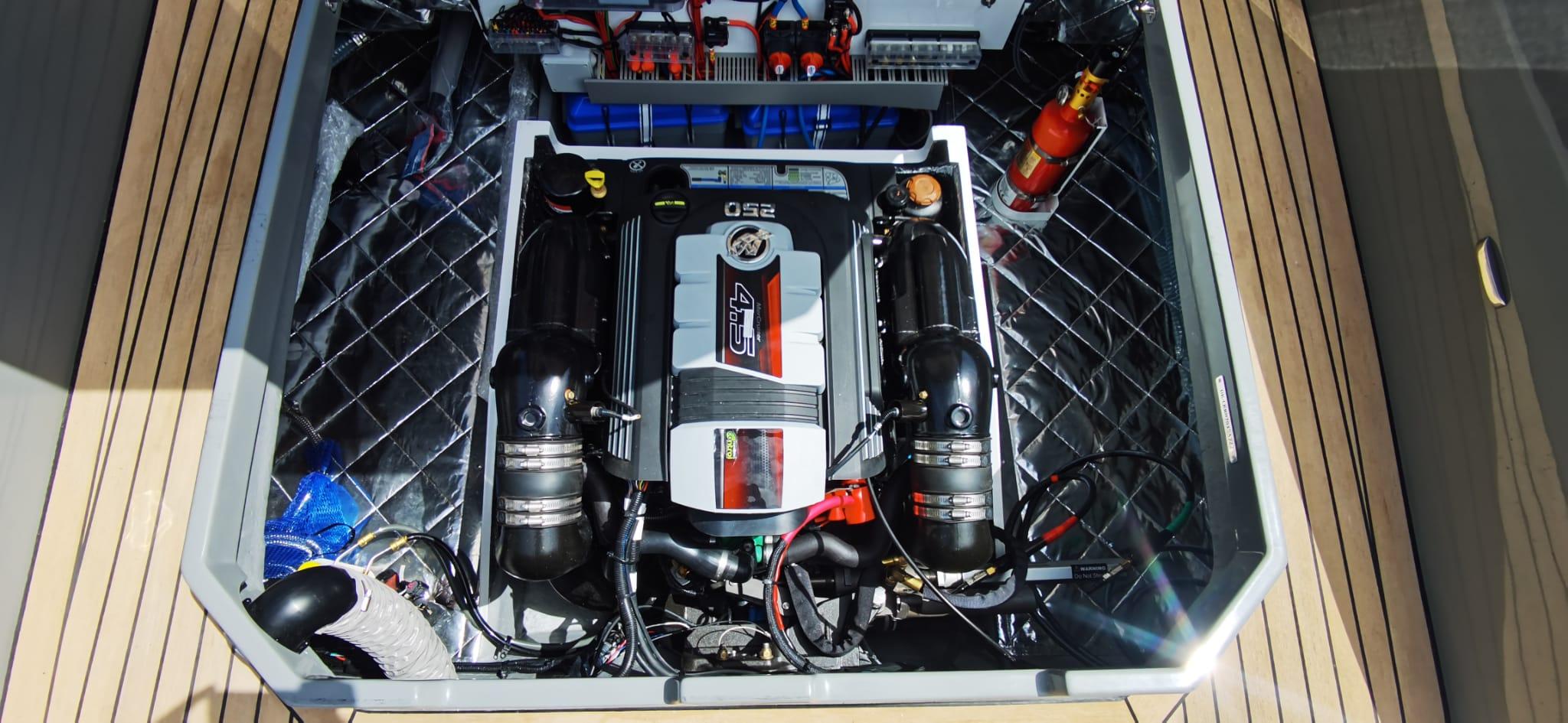 Engine compartment of 2022 Rand PLAY 24 boat, featuring a powerful inboard motor.