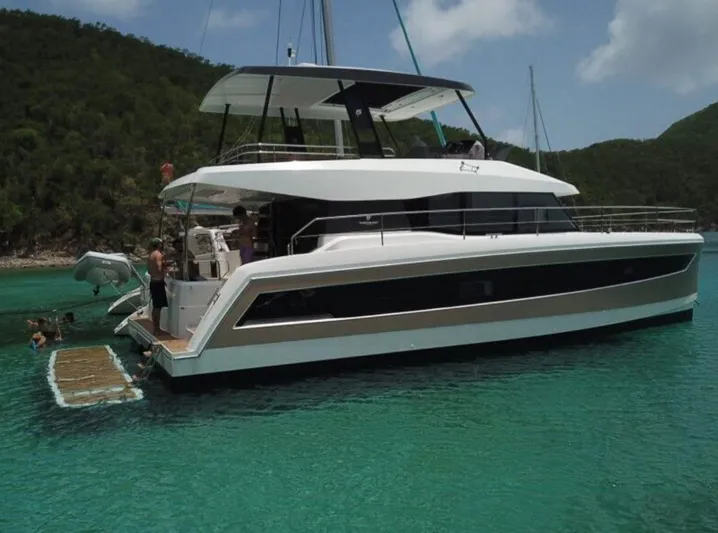  Yacht Photos Pics 2020 Fountaine Pajot MY 44 yacht anchored in clear turquoise water.