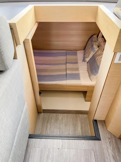  Yacht Photos Pics Cozy cabin interior of 2020 Fountaine Pajot MY 44 yacht with striped bedding.