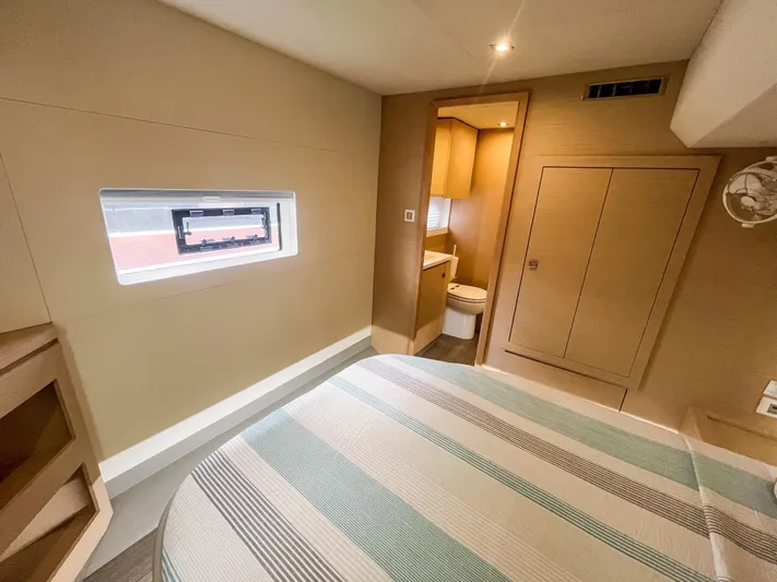  Yacht Photos Pics Modern bedroom interior on 2020 Fountaine Pajot MY 44 yacht, featuring a compact ensuite bathroom.