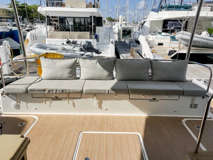 Yacht Photos Pics Fountaine Pajot MY 44 yacht deck with cushioned seating, docked at marina, 2020 model.