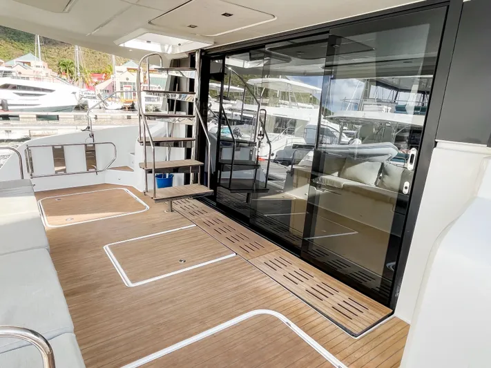  Yacht Photos Pics 2020 Fountaine Pajot MY 44 yacht deck with wooden flooring and glass doors.