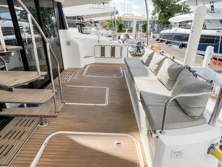  Yacht Photos Pics 2020 Fountaine Pajot MY 44 yacht deck with cushioned seating and wooden flooring.