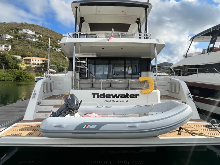  Yacht Photos Pics 2020 Fountaine Pajot MY 44 yacht docked with inflatable boat on deck.