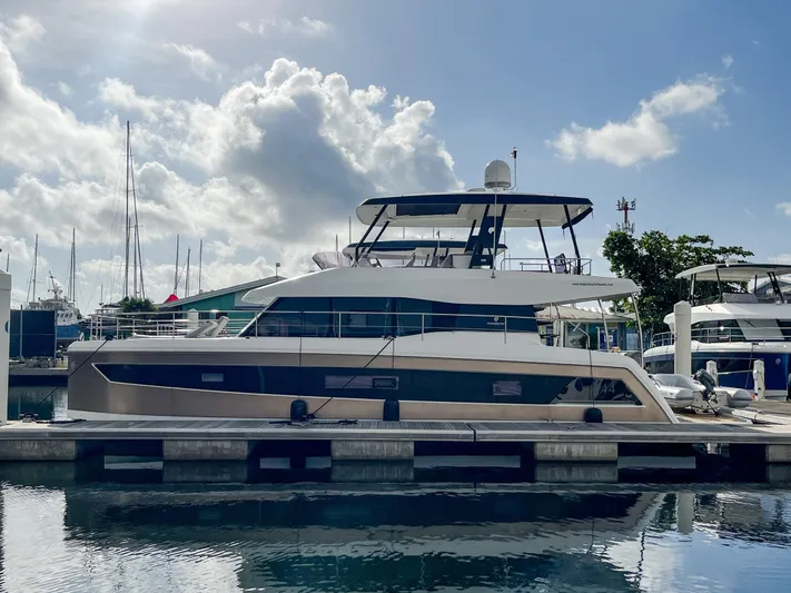  Yacht Photos Pics Fountaine Pajot MY 44 yacht, 2020 model, docked at marina under a partly cloudy sky.