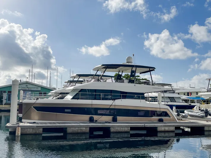  Yacht Photos Pics 2020 Fountaine Pajot MY 44 yacht docked at marina under blue sky.