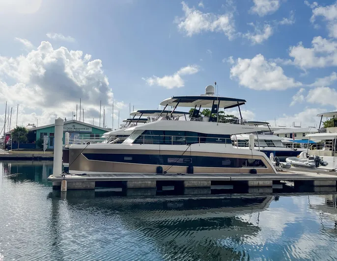  Yacht Photos Pics 2020 Fountaine Pajot MY 44 yacht docked at marina under blue sky.