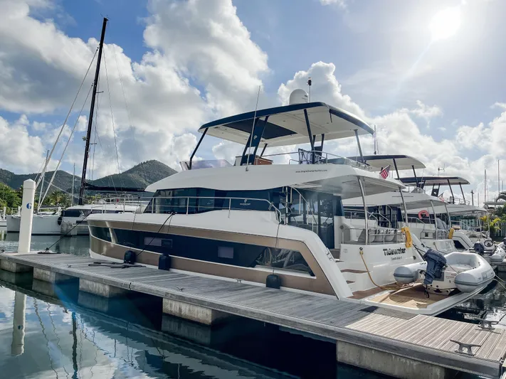  Yacht Photos Pics 2020 Fountaine Pajot MY 44 yacht docked at marina under a bright sky.