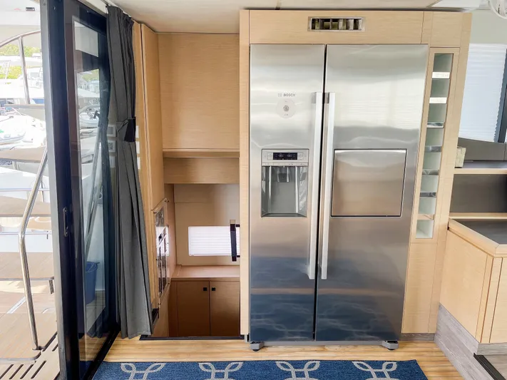  Yacht Photos Pics Modern kitchen area on 2020 Fountaine Pajot MY 44 yacht with stainless steel refrigerator.