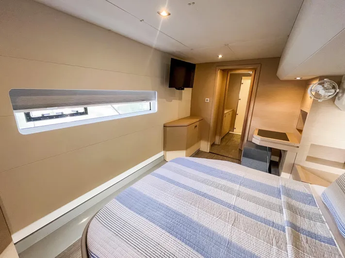  Yacht Photos Pics 2020 Fountaine Pajot MY 44 cabin interior with modern design and striped bedding.