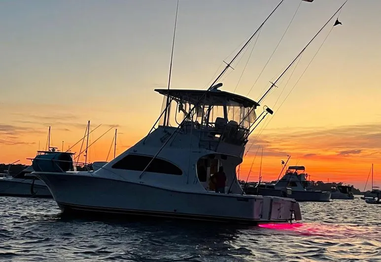  Yacht Photos Pics 2005 Luhrs 36 Convertible boat at sunset with vibrant sky.