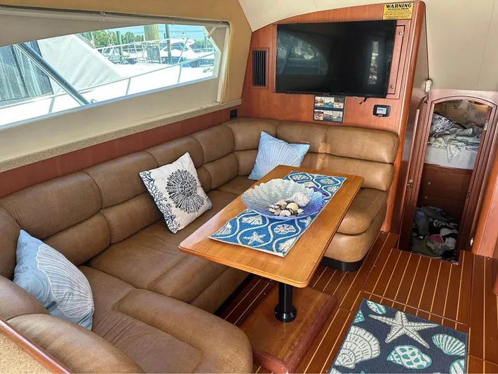  Yacht Photos Pics Luxurious interior of 2005 Luhrs 36 Convertible yacht with cozy seating and nautical decor.