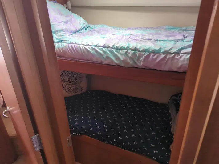  Yacht Photos Pics Bunk beds in 2005 Luhrs 36 Convertible boat cabin, featuring colorful bedding.