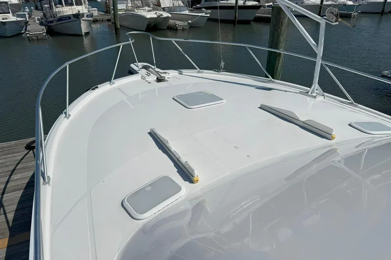  Yacht Photos Pics 2005 Luhrs 36 Convertible yacht bow view at marina, showcasing sleek design.