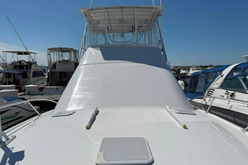 Yacht Photos Pics 2005 Luhrs 36 Convertible yacht docked at marina, clear sky background.
