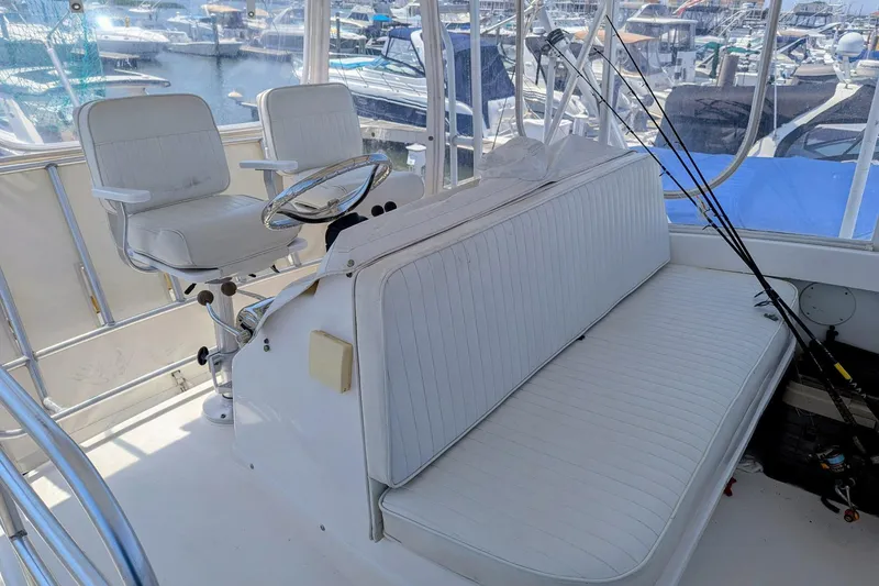  Yacht Photos Pics 2005 Luhrs 36 Convertible boat interior with white seating and fishing rods.