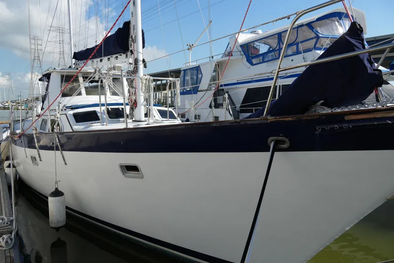 Peggy Lee Yacht Photos Pics 1984 Irwin 52 Cutter Ketch sailboat docked, featuring sleek design and blue accents.