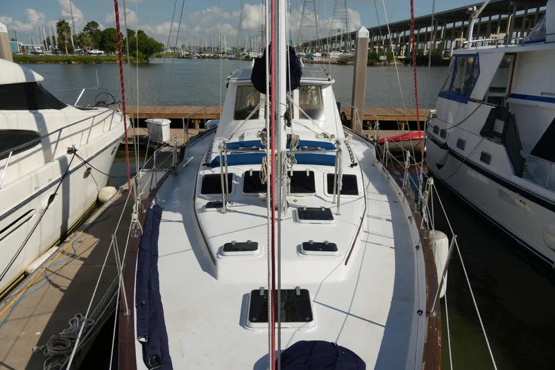 Peggy Lee Yacht Photos Pics 1984 Irwin 52 Cutter Ketch docked at marina, surrounded by other boats.