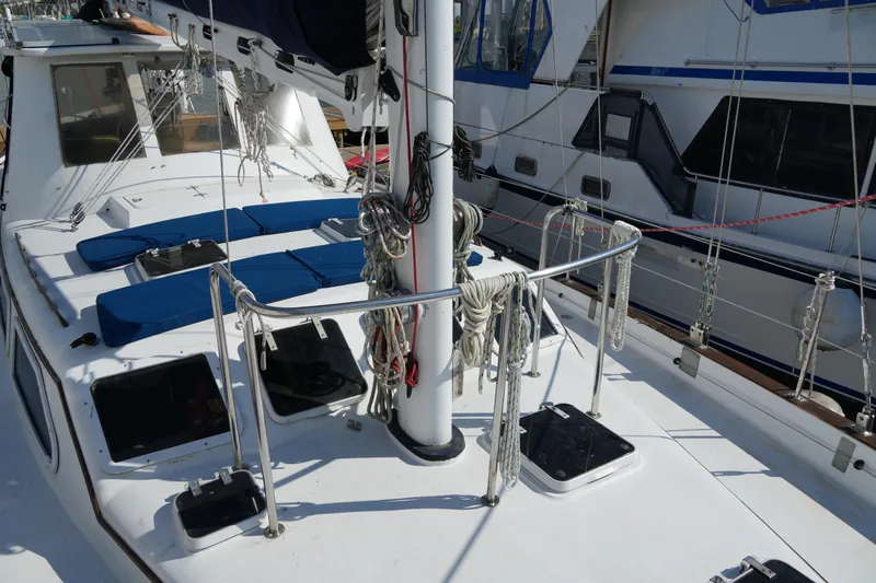 Peggy Lee Yacht Photos Pics 1984 Irwin 52 Cutter Ketch deck with ropes and hatches in marina setting.