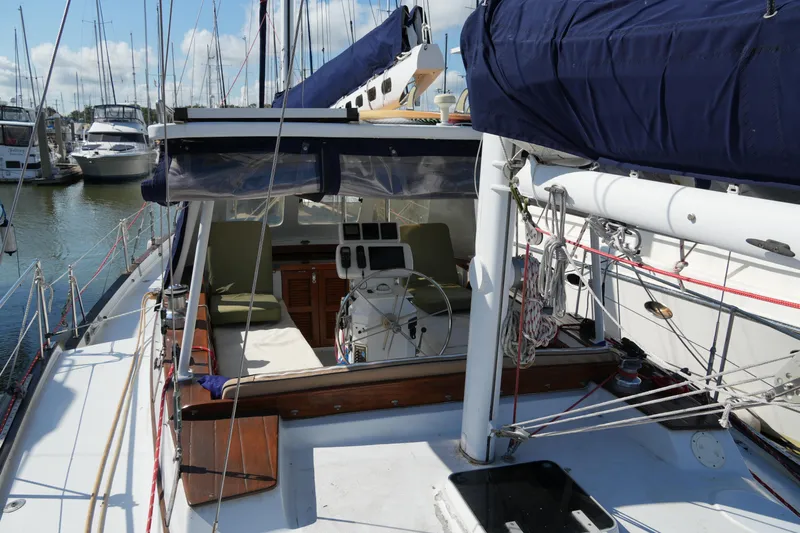 Peggy Lee Yacht Photos Pics 1984 Irwin 52 Cutter Ketch sailboat with blue sails docked at a marina.