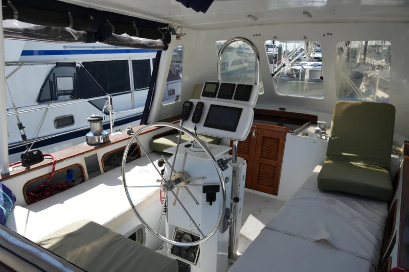 Peggy Lee Yacht Photos Pics 1984 Irwin 52 Cutter Ketch cockpit with steering wheel, navigation equipment, and seating.