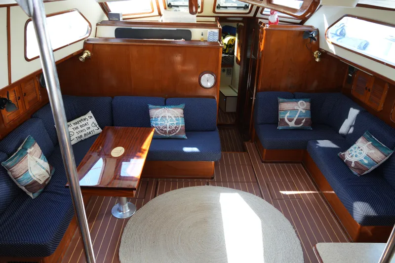 Peggy Lee Yacht Photos Pics Interior of 1984 Irwin 52 Cutter Ketch with nautical-themed decor and wooden furnishings.