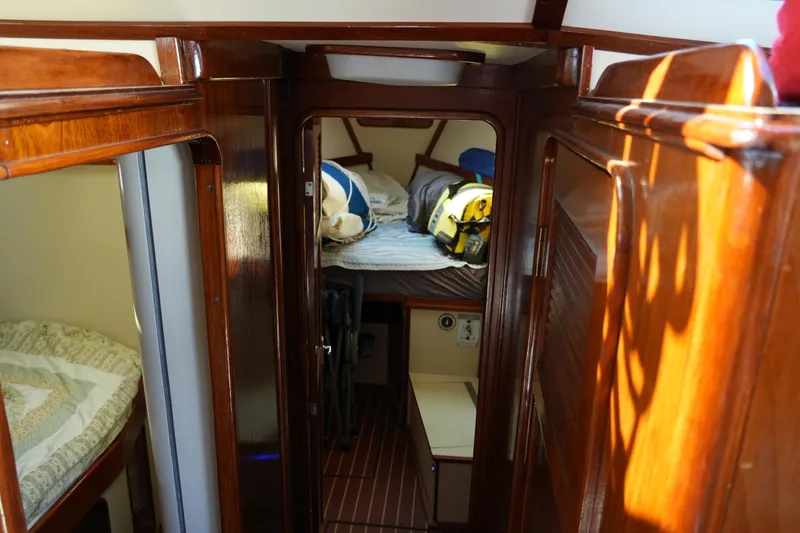 Peggy Lee Yacht Photos Pics Interior of 1984 Irwin 52 Cutter Ketch, featuring cozy wooden cabin and sleeping area.