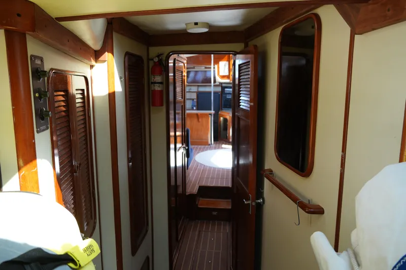 Peggy Lee Yacht Photos Pics Interior of 1984 Irwin 52 Cutter Ketch, featuring wooden paneling and nautical decor.