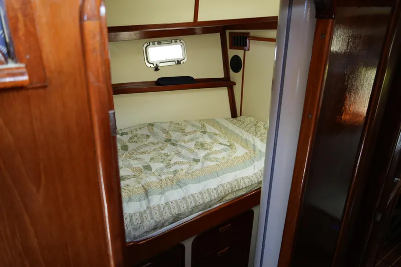 Peggy Lee Yacht Photos Pics Cozy cabin interior of 1984 Irwin 52 Cutter Ketch with wooden finish and bed.