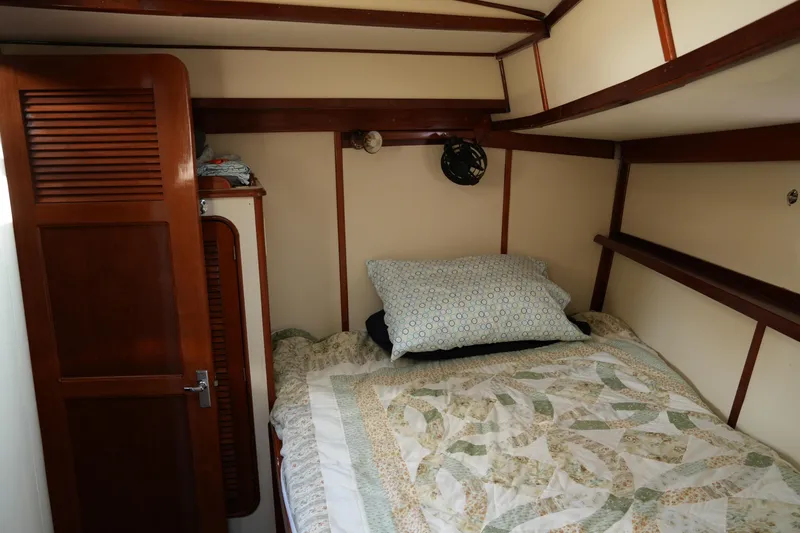 Peggy Lee Yacht Photos Pics Cozy cabin interior of 1984 Irwin 52 Cutter Ketch with bed and wooden accents.