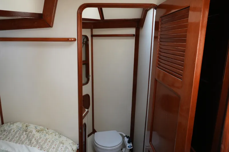 Peggy Lee Yacht Photos Pics 1984 Irwin 52 Cutter Ketch interior with wooden finish and compact bathroom.