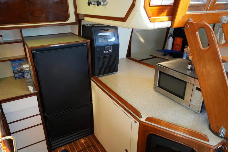 Peggy Lee Yacht Photos Pics Interior of 1984 Irwin 52 Cutter Ketch galley with appliances and wooden cabinetry.