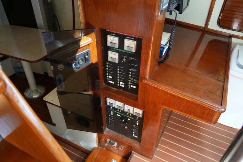 Peggy Lee Yacht Photos Pics Electrical panel on 1984 Irwin 52 Cutter Ketch, featuring wood finish and control gauges.