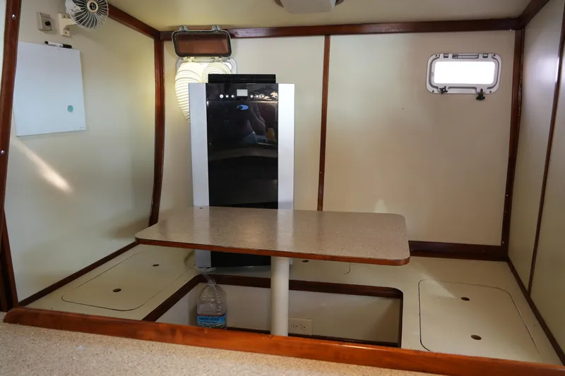 Peggy Lee Yacht Photos Pics Interior of 1984 Irwin 52 Cutter Ketch, featuring a compact dining area and storage.