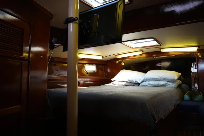 Peggy Lee Yacht Photos Pics Cozy cabin interior of 1984 Irwin 52 Cutter Ketch with bed and ambient lighting.